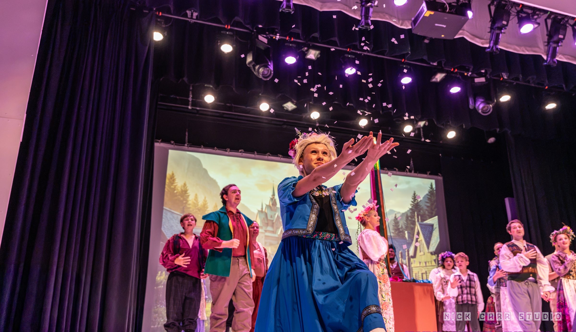 Elsa reaching toward falling snow during the Frozen finale